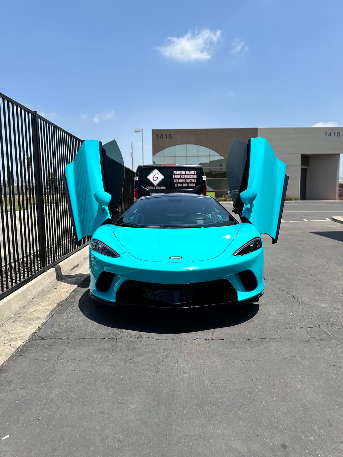 Turquoise McLaren GT with doors up after detailing in Orange County