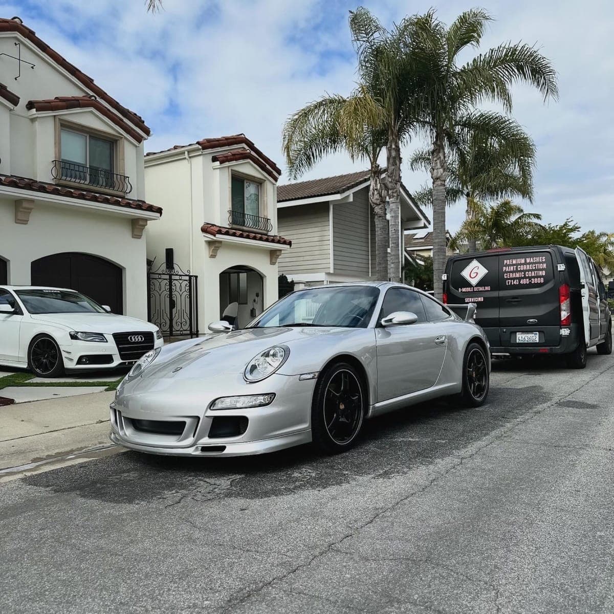 Silver Porsche 997 on driveway with G Mobile van in Orange County