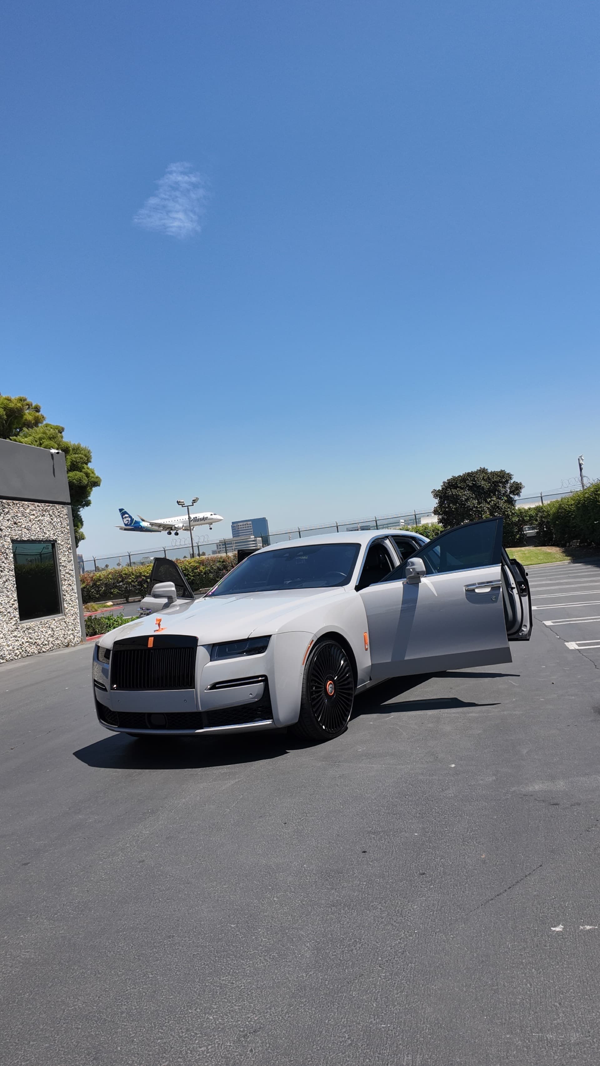 Gray Rolls Royce Ghost with ceramic coating and doors open after detail by G Mobile Detailing
